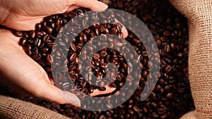 Coffee beans falling from hands.