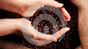 Coffee beans falling from hands.