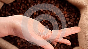 Coffee beans falling from hands.