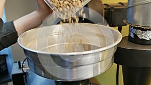 Coffee beans falling into roasting machine