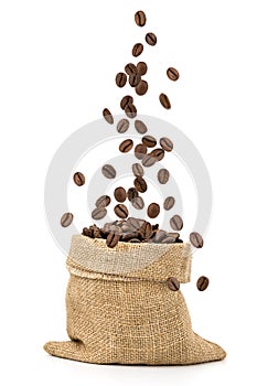 Coffee beans falling into sack bag
