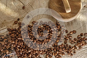 Coffee beans in glass jar with wood lid on solid wood creamy stump.