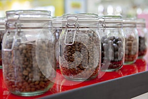 Coffee beans in glass jars on the cafe counter