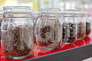 Coffee beans in glass jars on the cafe counter