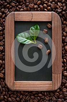 Coffee beans with green leaves on the chalkboard menu