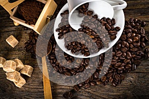 coffee beans with grinder and coffee cup