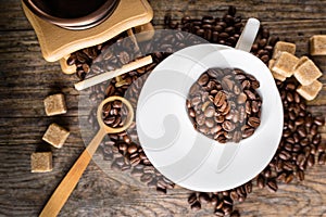 coffee beans with grinder and coffee cup