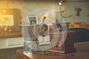 Coffee beans grinder and pot on table at cafe