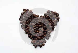 Coffee beans in heart form on white