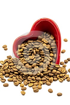 Coffee beans isolated on a white background. Full of coffee beans in a heart shaped plate