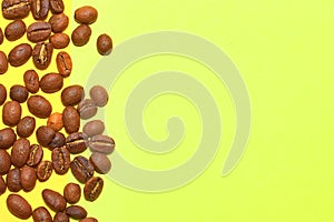 Coffee beans isolated on the yellow background. Joyful coffee-theme