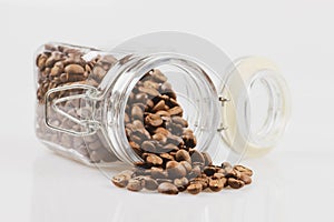 Coffee beans in a jar on white