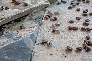 Coffee beans that lay scattered on the stone to a prop for shooting.