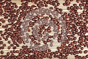 Coffee beans on a light brown striped background