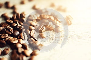 Coffee beans on light wooden background with copyspace for text. Coffee background, food frame, texture concept. Banner photo