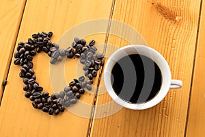 Coffee beans Love cup on wood table