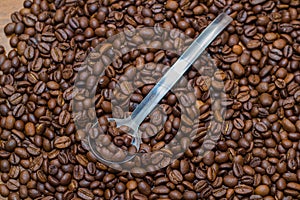 Coffee beans and metal spoon