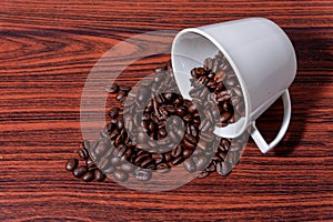 Coffee beans in a mug, Cup of coffee full of coffee beans, Coffee cup with roasted beans on stone background. Top view with copy photo