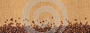 Coffee beans on natural burlap texture