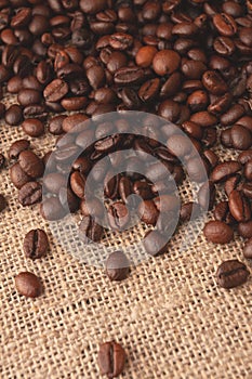 Coffee beans on burlap background