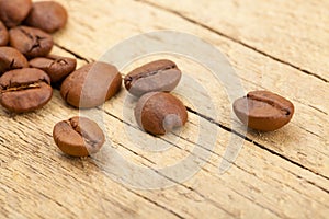 Coffee beans on old wooden table - close up studio shot