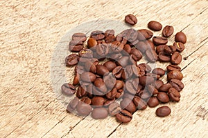 Coffee beans over old wooden table