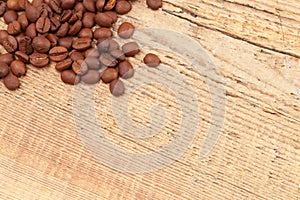 Coffee beans over old wooden table - close up shot