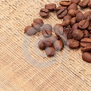 Coffee beans over wooden table - close up shot