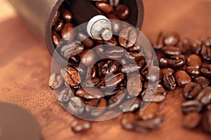 Coffee beans overflowing from the coffee mill