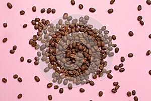 Coffee beans on a pink background from above,Coffee espresso.Coffee grains.Coffee black