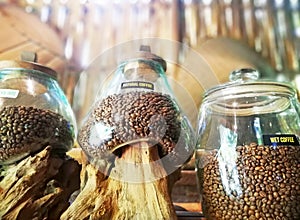 Coffee beans placed on the glass jar, in close up