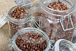 Coffee beans. Poured into cans with a yoke lock. Stand on linen and pine planks. Close-up shot