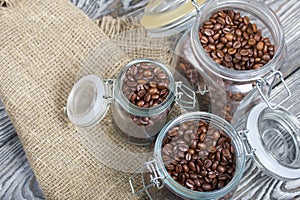 Coffee beans. Poured into cans with a yoke lock. Stand on linen and pine planks. Filmed from above