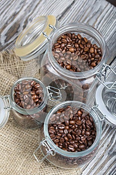 Coffee beans. Poured into cans with a yoke lock. Stand on linen and pine planks. Filmed from above