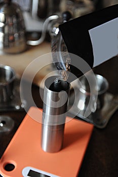 Coffee beans are poured into a coffee grinder. Empty label. Close up