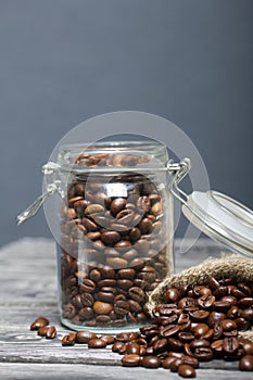 Coffee beans. Poured into a drag bag jar and linen bag. Close-up shot