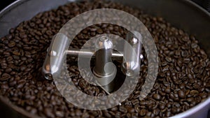 Coffee beans process at roasting plant. Industrial electric cooling tray