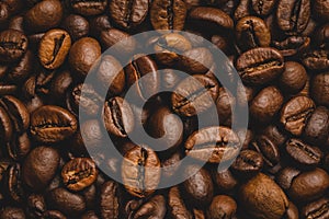 Coffee beans roasted full frame background Close up macro dark brown