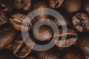 Coffee beans roasted full frame background Close up macro dark brown