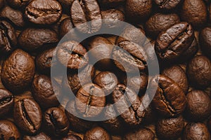 Coffee beans roasted full frame background Close up macro dark brown