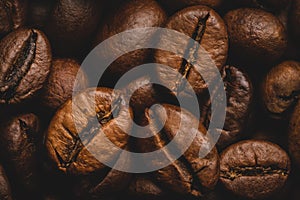 Coffee beans roasted full frame background Close up macro dark brown