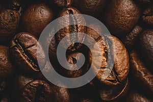 Coffee beans roasted full frame background Close up macro dark brown