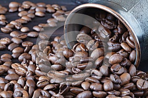 Coffee beans roasted isolated on wooden background close up cut out in cup