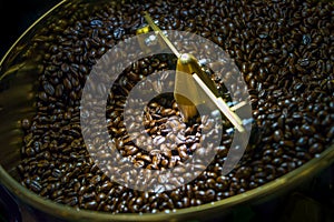 Coffee beans roasted in coffee roasters machine photo