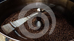 coffee beans and roasted spinning cover professional machine, close up to soft focus, take low speed photo to need movement and