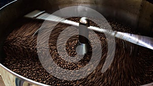 coffee beans and roasted spinning cover professional machine, close up to soft focus, take low speed photo to need movement and