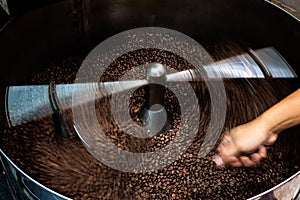 coffee beans and roasted spinning cover professional machine, close up to soft focus, take low speed photo to need movement and