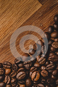 Coffee beans roasted on wooden background Close up macro copy space