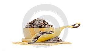 Coffee beans roasted in a wooden bowl and beans scoop on sackcloth isolated over white background
