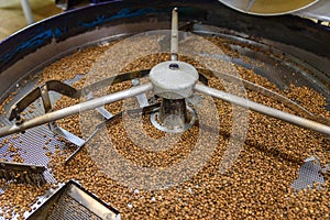 Coffee beans during the roasting process. Drum type roaster. Rosting process of coffee